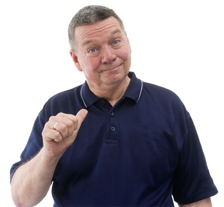 portrait of mature man wearing a dark blue polo shirt, smiling and pointing with thumb to himself, isolated on a white background.の写真素材