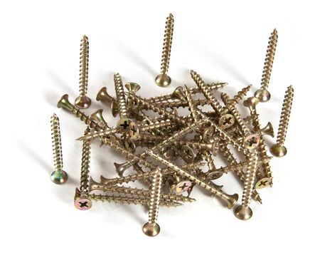 Golden colored deck screws isolated on a white backgroundの写真素材
