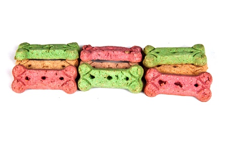 Multicolored dog treat biscuits, isolated on whiteの写真素材