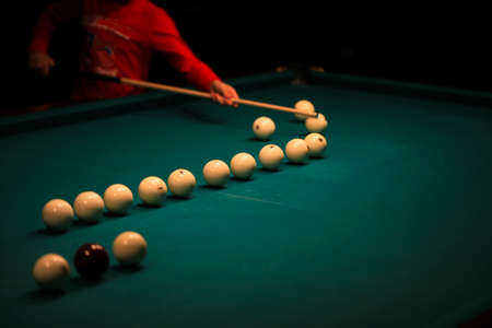 Playing billiard. Billiards balls and cue on green billiards table. Billiard sport concept. Pool...