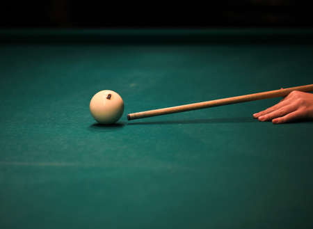Playing billiard. Billiards balls and cue on green billiards table. Billiard sport concept. Pool...