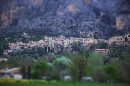 Medieval village of Moustier-Sainte-Marie, Provence, France - May 02,2013. A view of the mountains in cloudy weather and colorful facades of housesTtilt shift effect.のeditorial素材