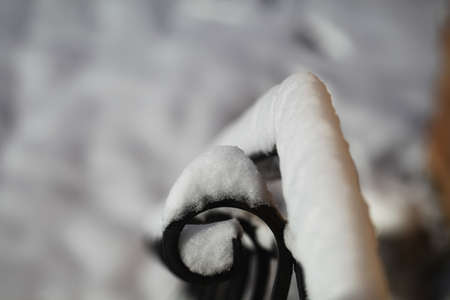 Iron railing covered with morning frost. Snow and ice texture.の写真素材