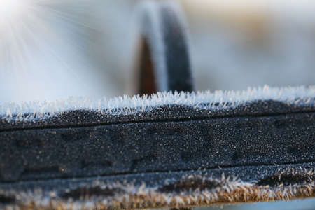 Iron railing covered with morning frost. Snow and ice texture. Natural abstraction.の写真素材