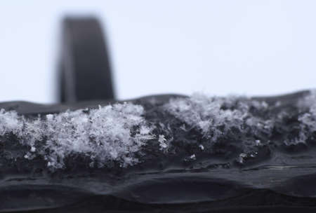 Iron railing covered with morning frost. Snow and ice texture. Black and white photography.の写真素材