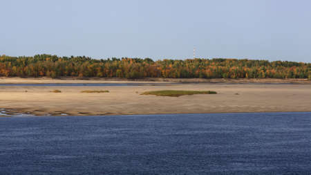 A natural blurred landscape of the river in autumn. Astrakhan Region, Russia. Defocused. River sand...