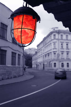 evening on old blue town street with red torchの写真素材
