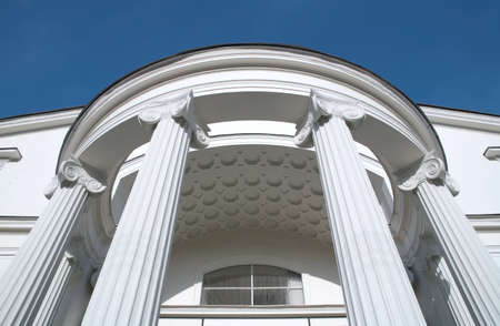 fragment old-time brightly white building on background blue sky, theatre Sovremennik on Chistye...
