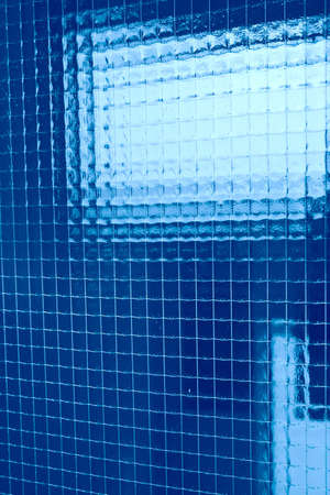 abstraction, blue plaid background from fine wire in glassの写真素材