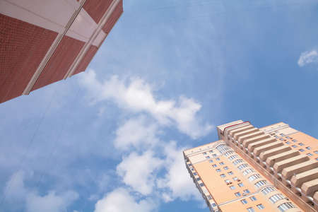 blue sky with cloud under new red skyscrapersの写真素材