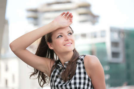lucky smile of the young girl with hand near face
