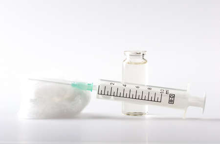 Syringe for In'ekciy, Lying on Cotton wool and Ampule with Liquidの写真素材
