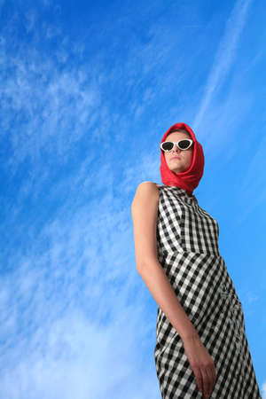 young girl in image of the 50-h on blue sky background with copy-spaceの写真素材