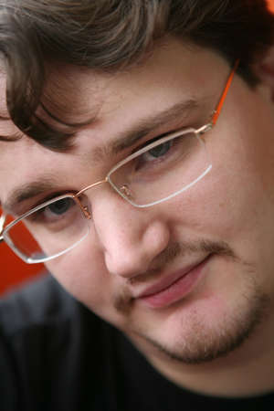 close-up portrait of the young man in glasses