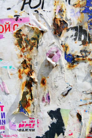 surface of the billboard with scrap of the paper announcements and posters