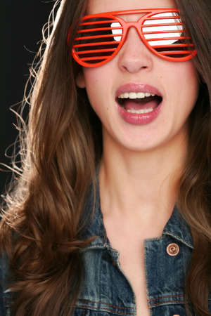 portrait of the beautiful girl in red sunglassesの写真素材