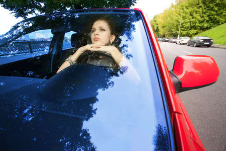 beautiful woman dreaming inwardly of car