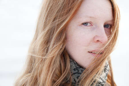 romantic portrait of a young white woman with windの写真素材