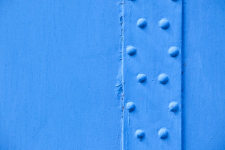 painted metallic blue background with rivetsの写真素材