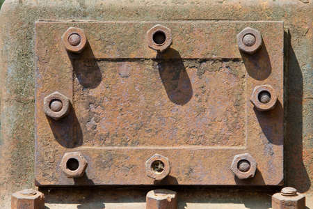 rusty metal hatch with nutsの写真素材