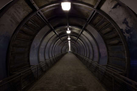 concentric dark tunnel with lightの写真素材