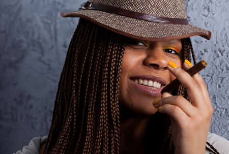 close-up portrait of a black young woman with a cigarの写真素材