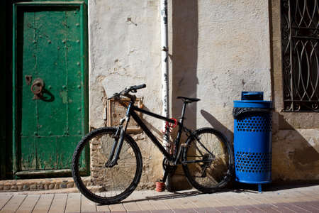 old bicycle near the ancient walls and doorsの写真素材