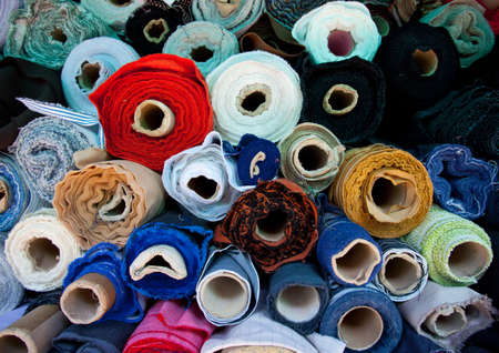 multicolored rolls of fabric at a flea marketの写真素材
