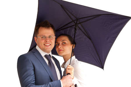 Successful business couple under an umbrella on a white superの写真素材