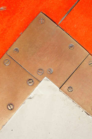 Brass metal plate with screw heads, texture