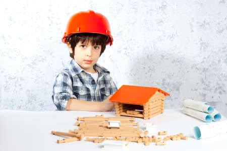 boy builder in red helmet  built a new homeの写真素材