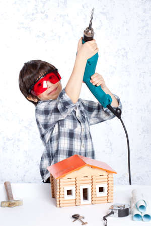 boy with a drill and a new homeの写真素材