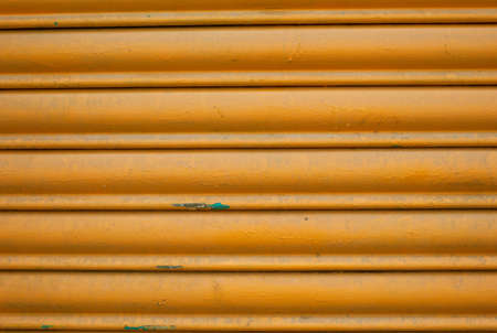 old painted orange blinds, striped backgroundの写真素材