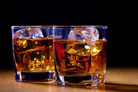 Two glasses of whiskey on old blackboardの写真素材