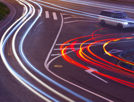 evening crossroad with varicolored lines of lights of cars. abstraction