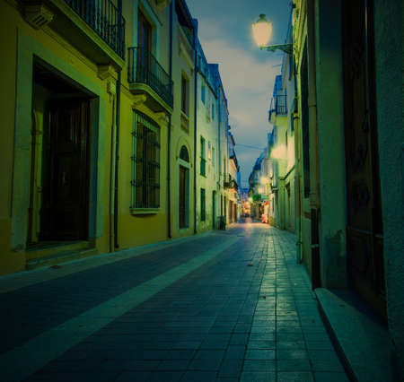 old town street lights illuminated at nightの写真素材
