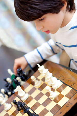 boy learning to play chessの写真素材