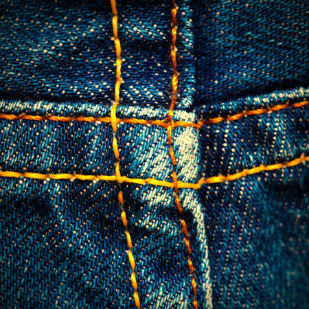 old jeans surface with seams, close up.