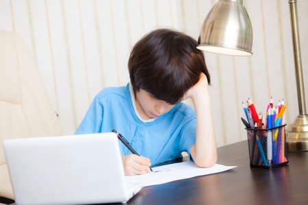 schoolboy doing homework, portrait