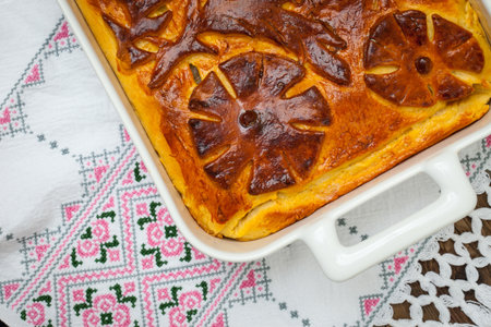 Kulebyaka. cabbage pie on the embroidered cloth. Russian cuisine