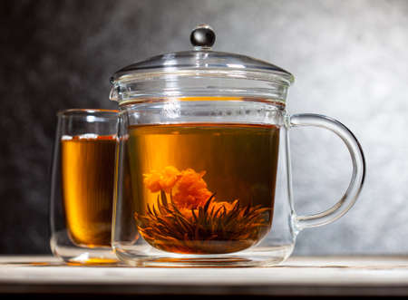 chinese green tea with flower in transparent glass teapot