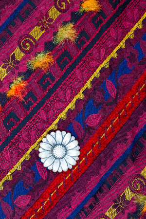 still life, vintage varicolored tape with embroidered ornaments and one old flower buttonの写真素材