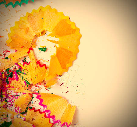 colored pencils shavings on white background with copy space, carnival. image retro style