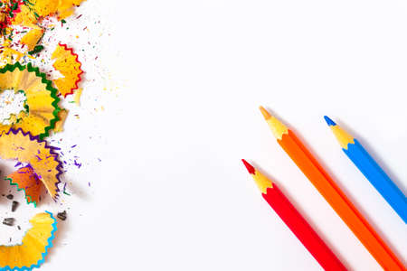 colored pencils and shavings on a white background