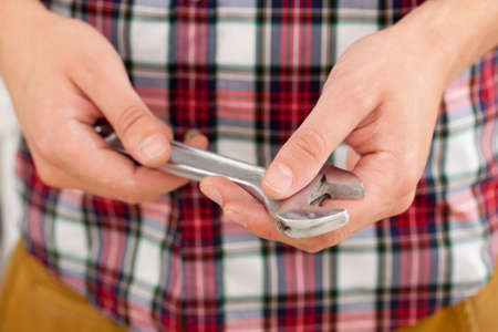 Hands of professional Plumber with a wrenchの写真素材