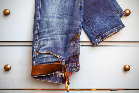 Jeans hanging from a drawer