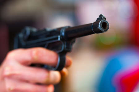 Luger Parabellum automatic pistol in a human hand, shallow depth of field. close-upの写真素材