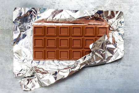 milk chocolate bar in foilの写真素材
