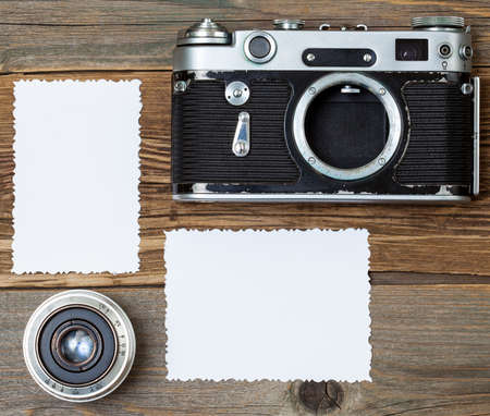 blank photo with vintage camera and lens on old textured boardsの写真素材