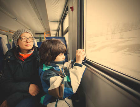 Mother and son in a railway carriage. winter trip. instagram image filter retro styleの写真素材